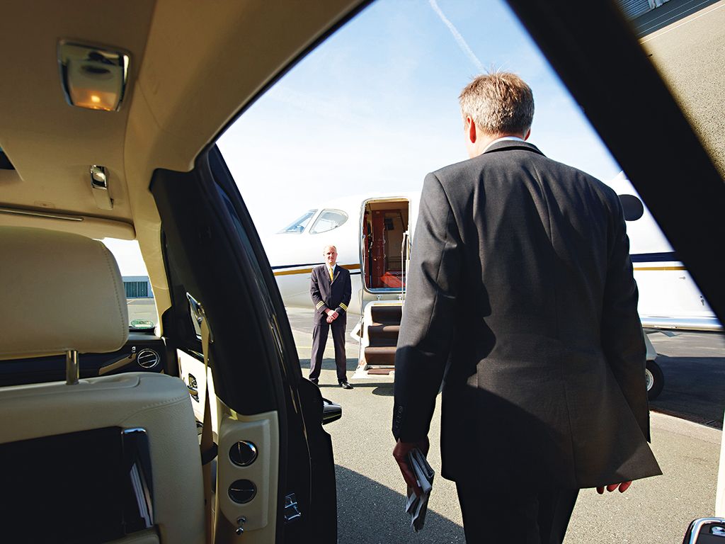 Businessmen steps out of a private jet
