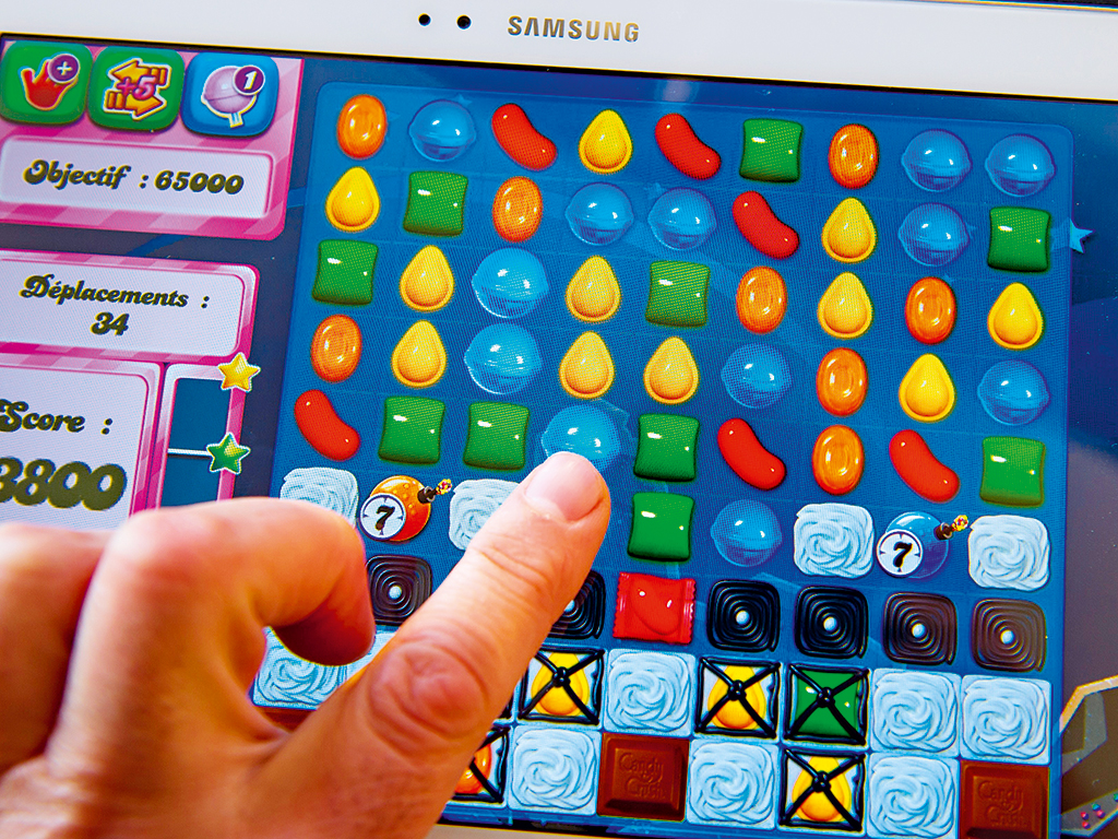 A tablet-user plays Candy Crush Saga