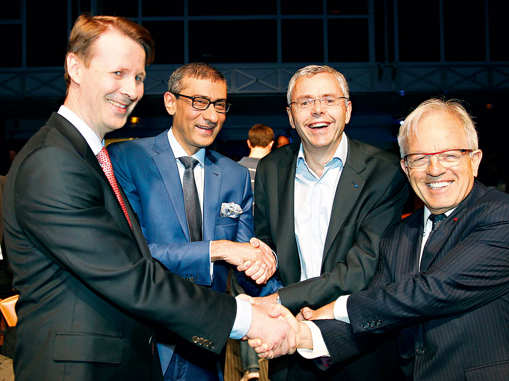 Rajeev Suri (centre left) meets executives from Alcatel-Lucent, after agreeing the Nokia’s takeover of the company